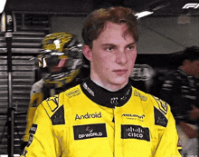 a man wearing a yellow jacket with android and cisco on the front