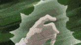 a hand is reaching out towards a green leaf