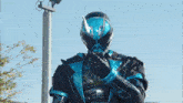 a man in a blue and black costume is holding a gun .