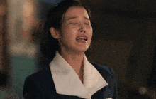 a woman is crying with her eyes closed