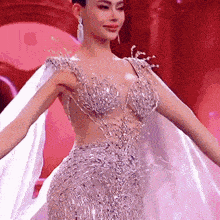 a woman is wearing a very revealing dress with a cape .