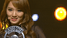 a woman wearing a ladies code shirt is clapping her hands