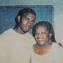 a man and a woman are posing for a picture and smiling for the camera .