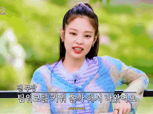 a woman in a blue sweater with pinked out written on the bottom of the screen