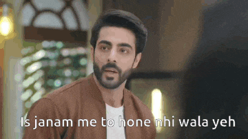 a man with a beard is wearing a brown jacket and a white shirt and is talking to someone .