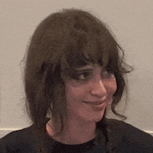 a close up of a woman 's face with her eyes closed