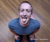 a man sticking his tongue out in front of a wooden floor