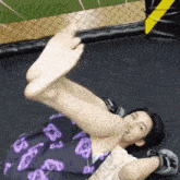 a person is laying on a trampoline with their feet up