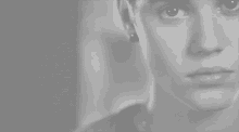 a close up of a man 's face with a serious look on his face .