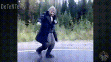 a man is walking down a road with the word detente on the bottom right