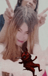 a man and a woman are giving a peace sign with a devil in the background
