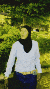 a woman wearing a hijab and a white sweater