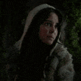 a woman wearing a fur coat and a hooded sweatshirt