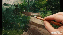 a person is painting a picture with the words made in animotica visible
