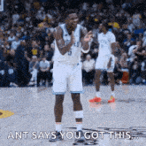 a basketball player is standing on the court and says `` ant says you got this ''