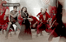 a group of people are dancing on a stage and the website kulfyapp.com is visible in the corner