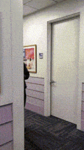a hallway with a picture on the wall and a door