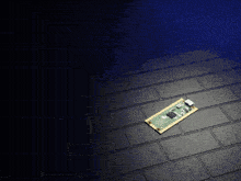 a piece of electronic equipment is laying on a black tile floor