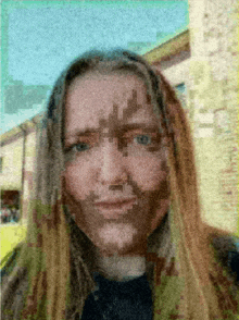 a pixelated image of a woman 's face shows a cross on her forehead