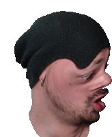 a man wearing a black beanie has his tongue hanging out