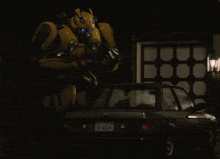 a transformer is standing next to a car with a california license plate