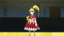 a girl in a red dress is holding a yellow object in her hand