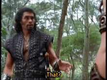 a man with a beard is talking to another man in the woods and says that