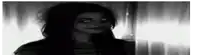 a black and white photo of a woman with glowing eyes