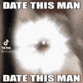 a blurred image of a person 's eye with the caption date this man date this man