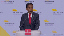 a man in a suit and tie stands at a podium with the words " not anle " above him
