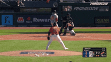 a baseball game is being played in front of progressive advertising