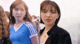 a woman in a blue shirt and a woman in a black shirt
