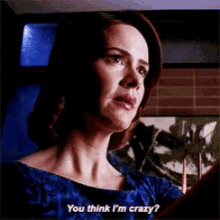 a woman in a blue dress is asking if she is crazy