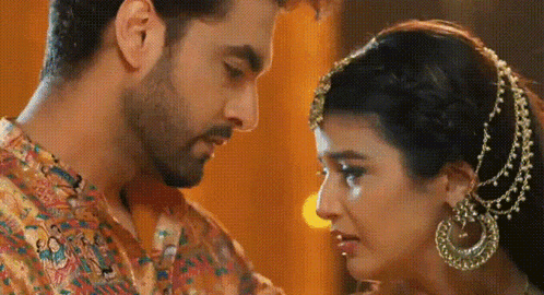 a man and a woman are looking into each other 's eyes . the woman is crying .