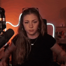 a woman is sitting in front of a microphone .