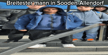 a group of people standing on stairs with breitester mann in sooden-allendorf written above them