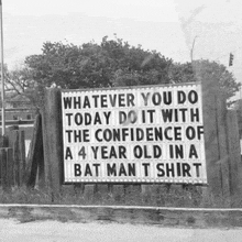 a sign that says whatever you do today do it with the confidence of a 4 year old in a batman t shirt .