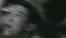 a black and white photo of a person 's face with a polka dot pattern .