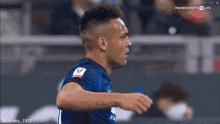 a soccer player with a tattoo on his arm is celebrating