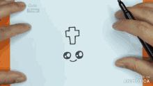 a person is drawing a cross on a piece of paper with a pen