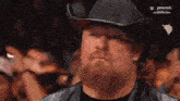 a man with a beard wearing a cowboy hat and a leather jacket