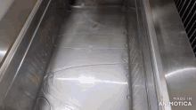 an empty stainless steel container with the words made in animatica on the bottom