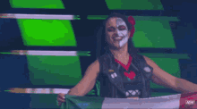 a woman holding a flag with aew written on the bottom right