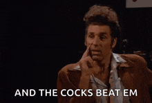 a man with curly hair is pointing at the camera and says `` that 's true and the cocks beat em ''