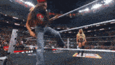 two women are wrestling in a ring with the word ram on the wall