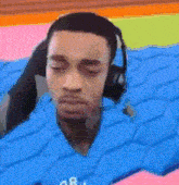 a man wearing headphones is laying in a pile of blue foam .