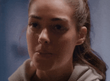a close up of a woman 's face looking at the camera