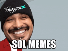 a smiling man wearing a beanie that says blazzard on it
