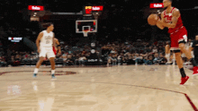 a basketball game is being played in front of a crowd and a sign that says fedex on it