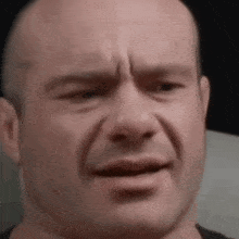 a close up of a man 's face with a sad expression .